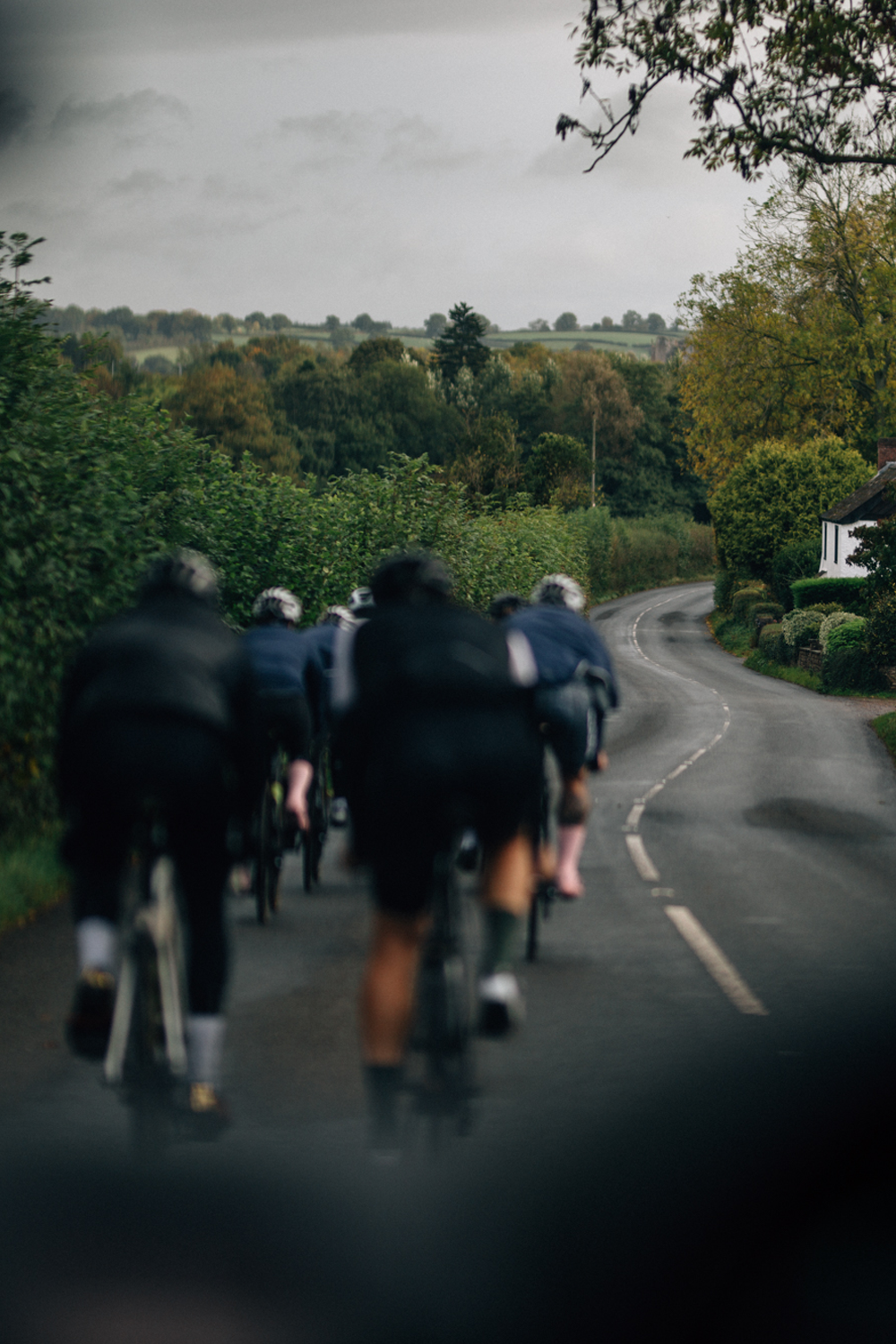 ManRide cyclists riding along a winding country road